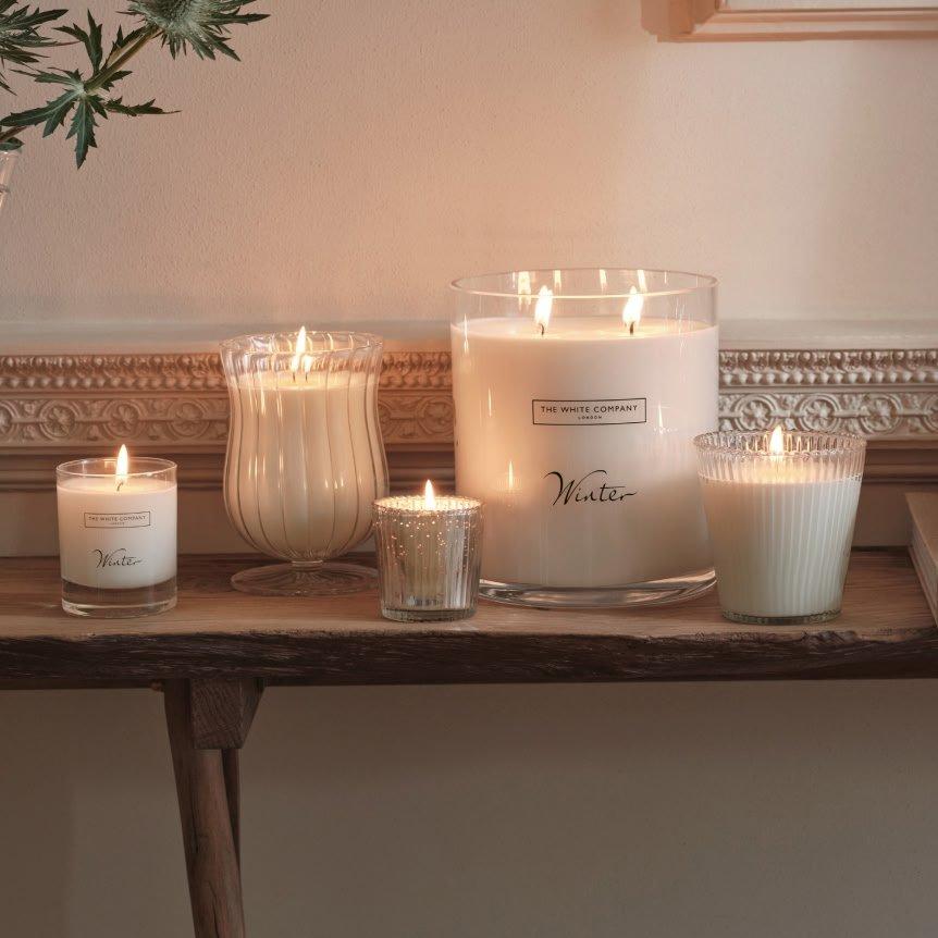a table with candles on it and a plant on the table