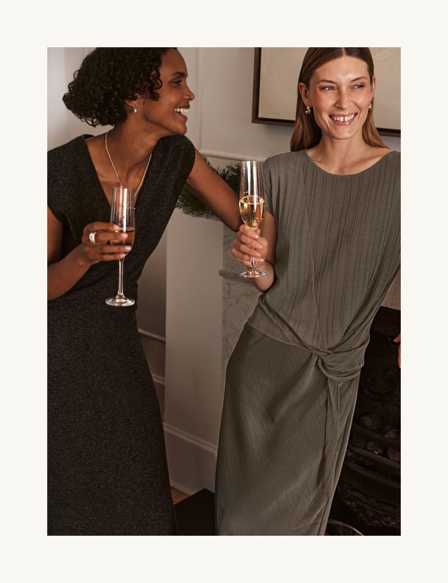a white teapot and cup on a table with a plate of cookies