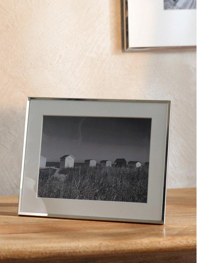a picture of a picture frame sitting on a table next to a clock