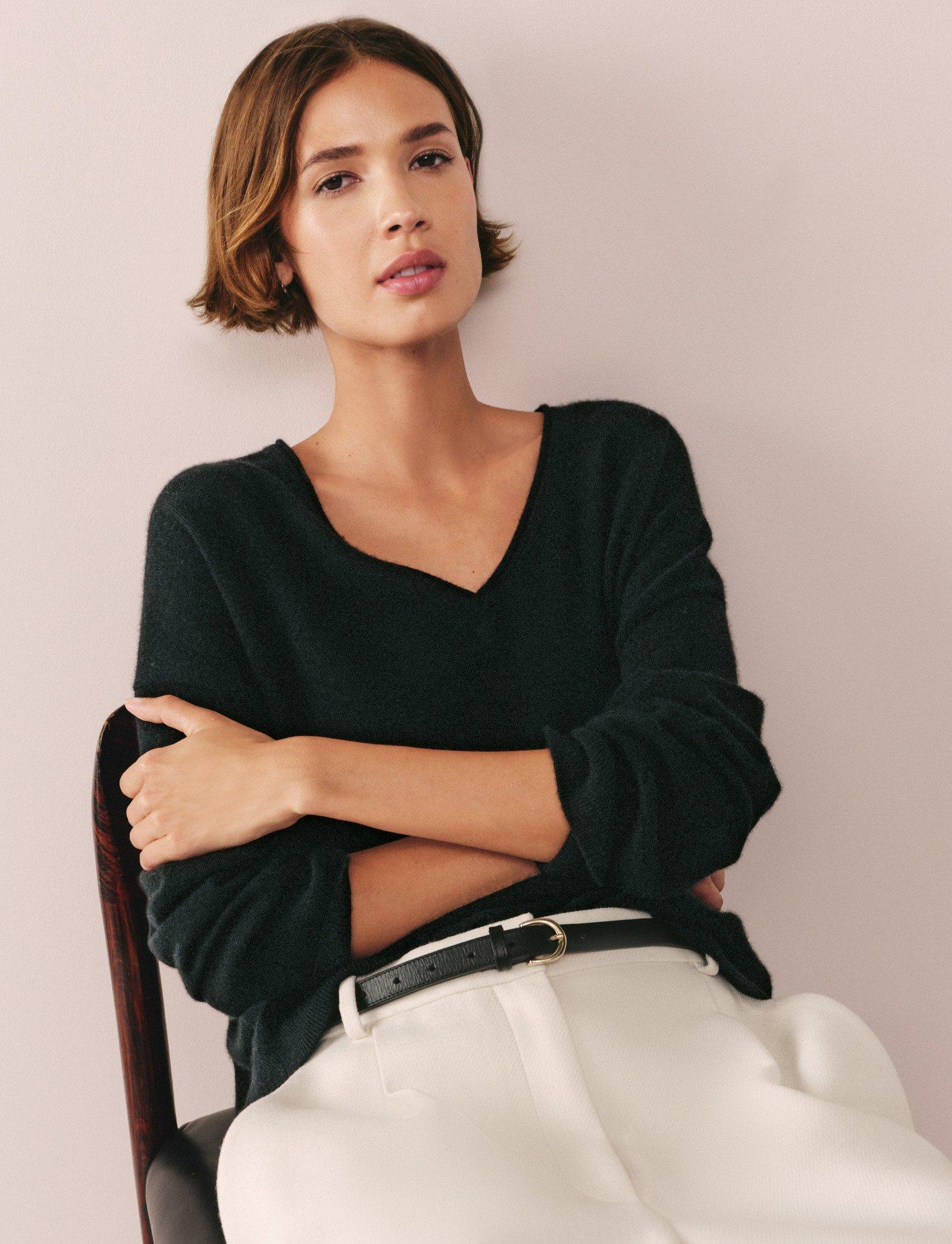 a woman sitting in a chair with a tennis racket in her hand