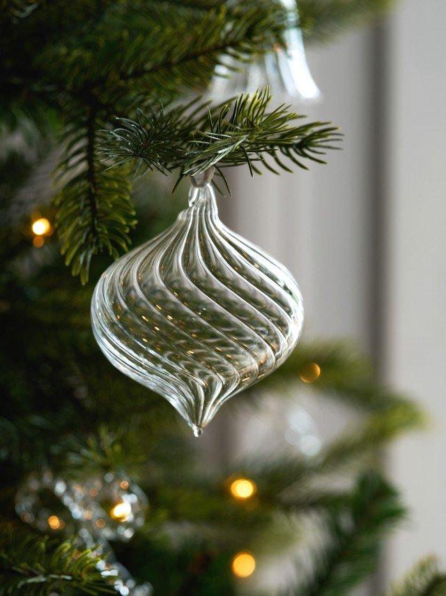 a close up of a glass ornament hanging from a christmas tree