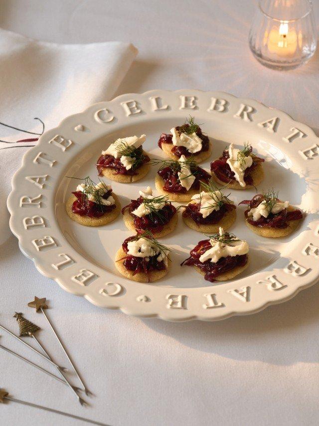 a plate of small appetizers on a table with candles