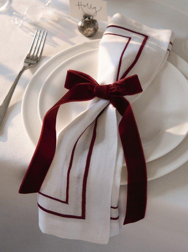 a white plate with a red and white napkin on it
