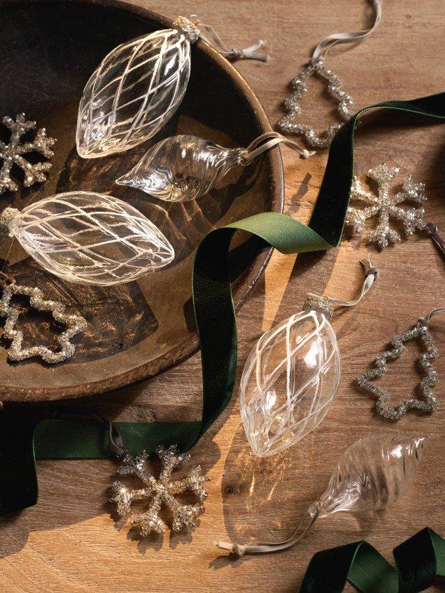 a bowl of ornaments and ribbons on a table