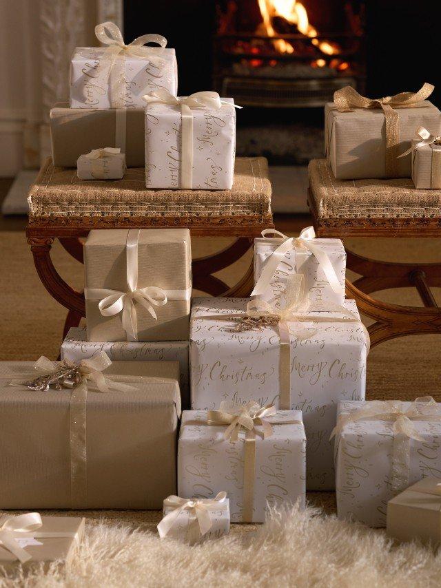 a bunch of presents sitting on a table in front of a fireplace
