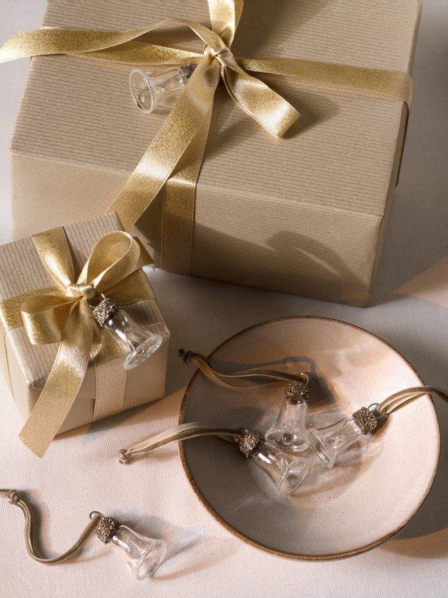 a white bowl with a bow on top of it next to a box