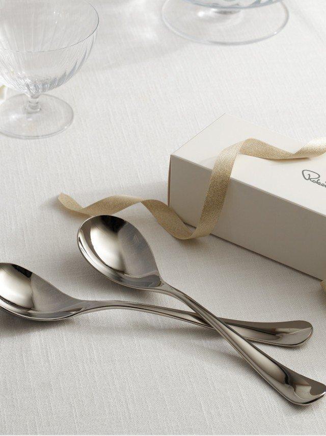 a white table with two spoons and a box of wine