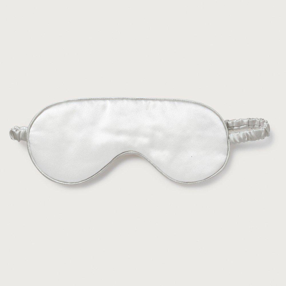 a white sleep mask with a silver cord
