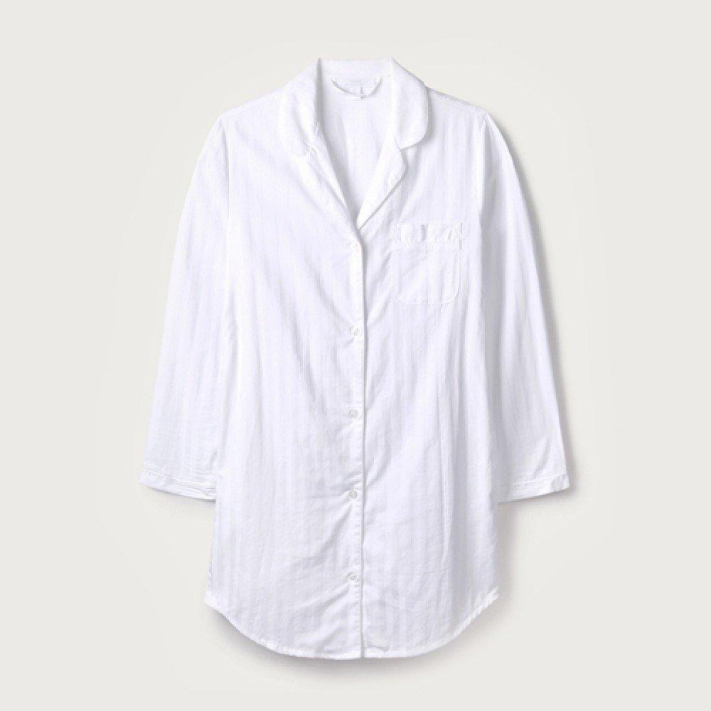 a white shirt that is hanging on a hanger