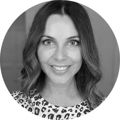 a woman with a leopard print shirt and a smile