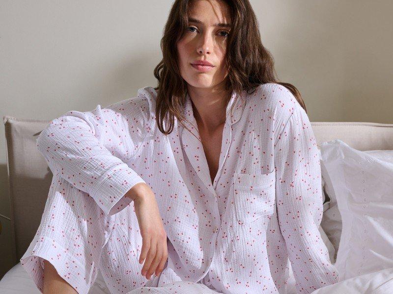 a woman laying in bed with breakfast and coffee