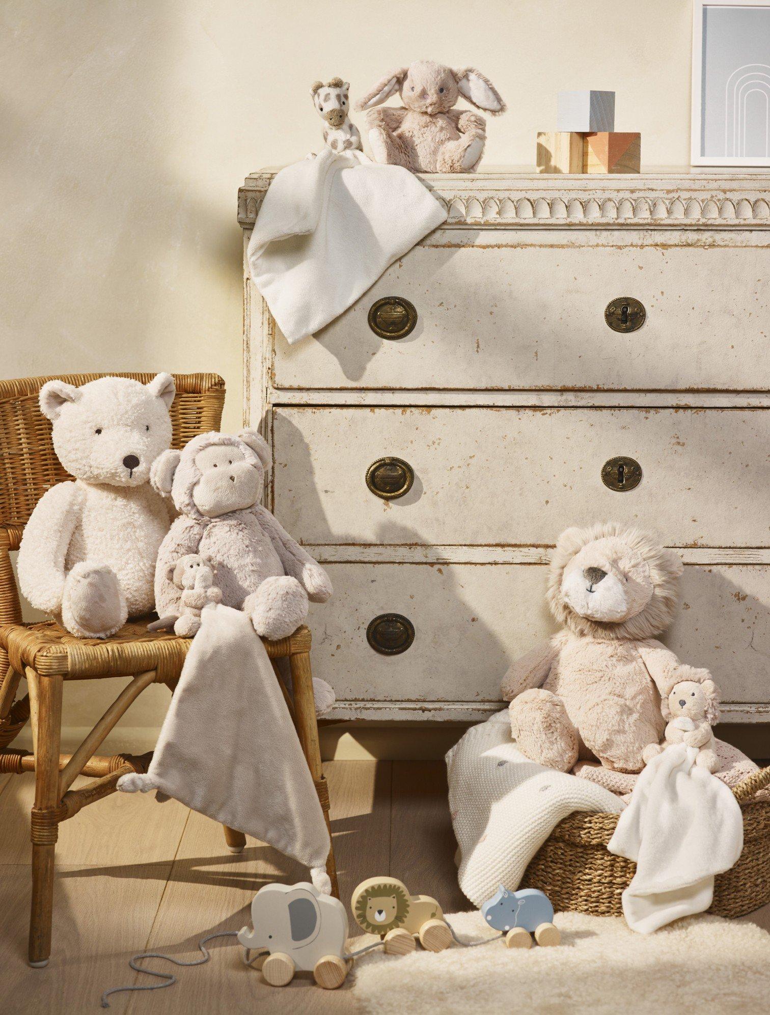 a group of stuffed animals sitting on a chair in a room