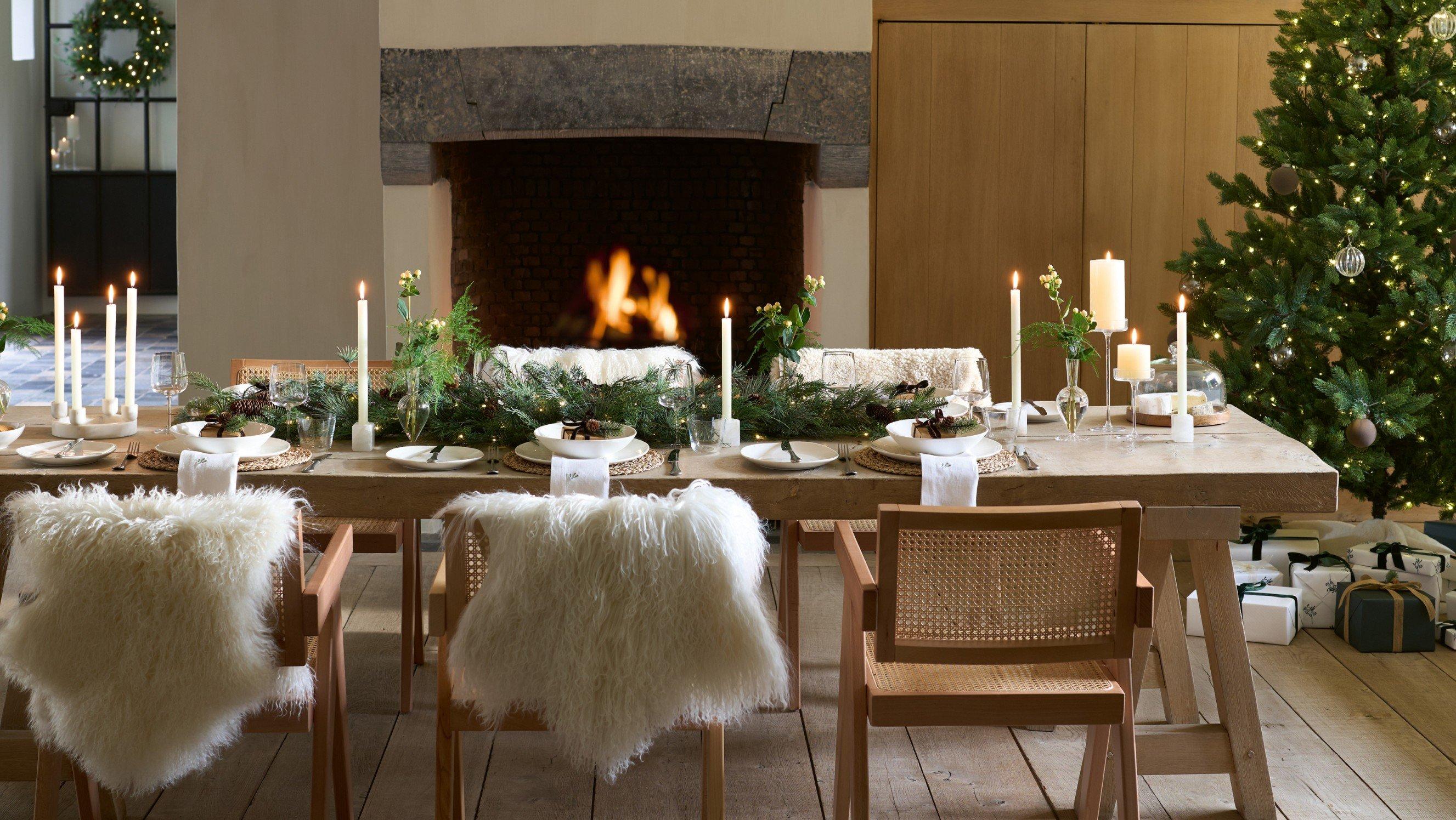 a dining room with a christmas tree and a fireplace