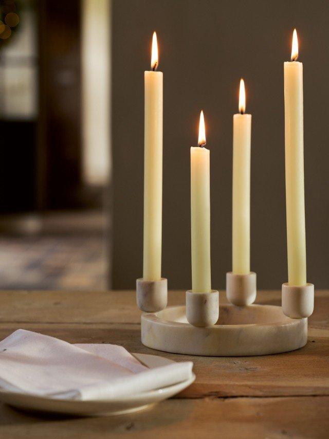 a group of candles on a table with a napkin