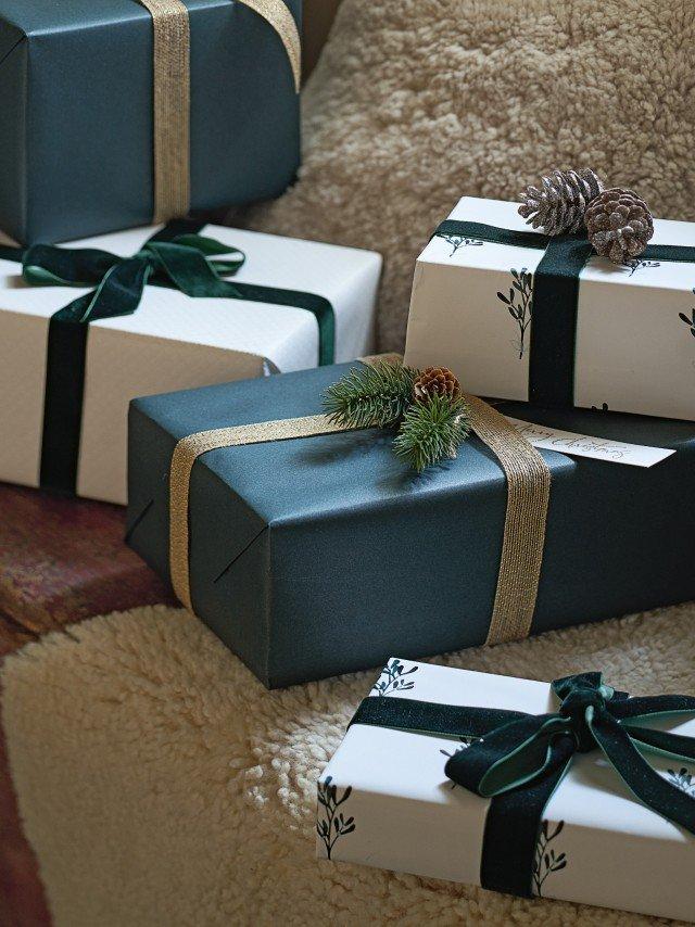 a group of presents wrapped in green and brown paper on a couch