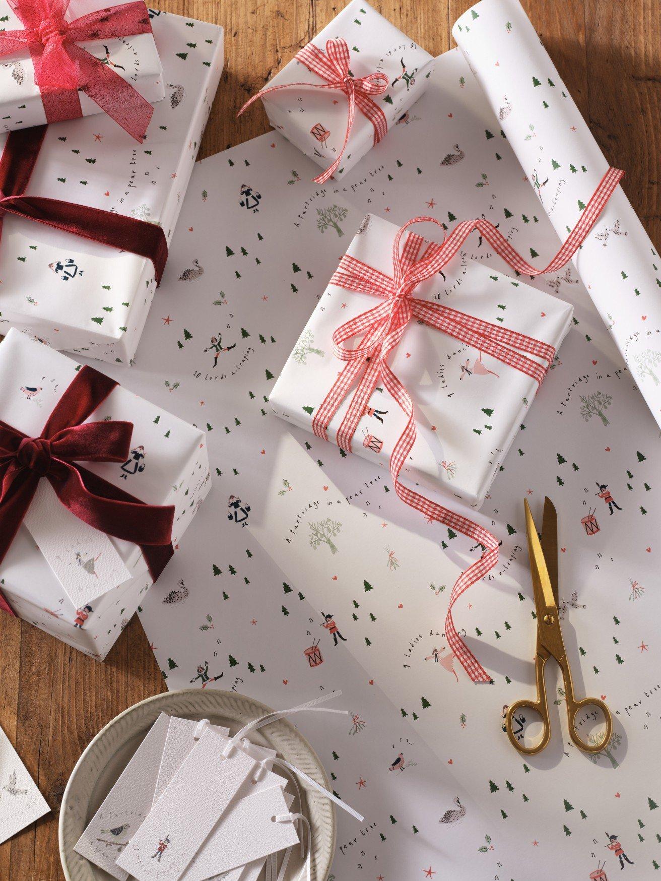 a table with wrapped gifts and scissors on it