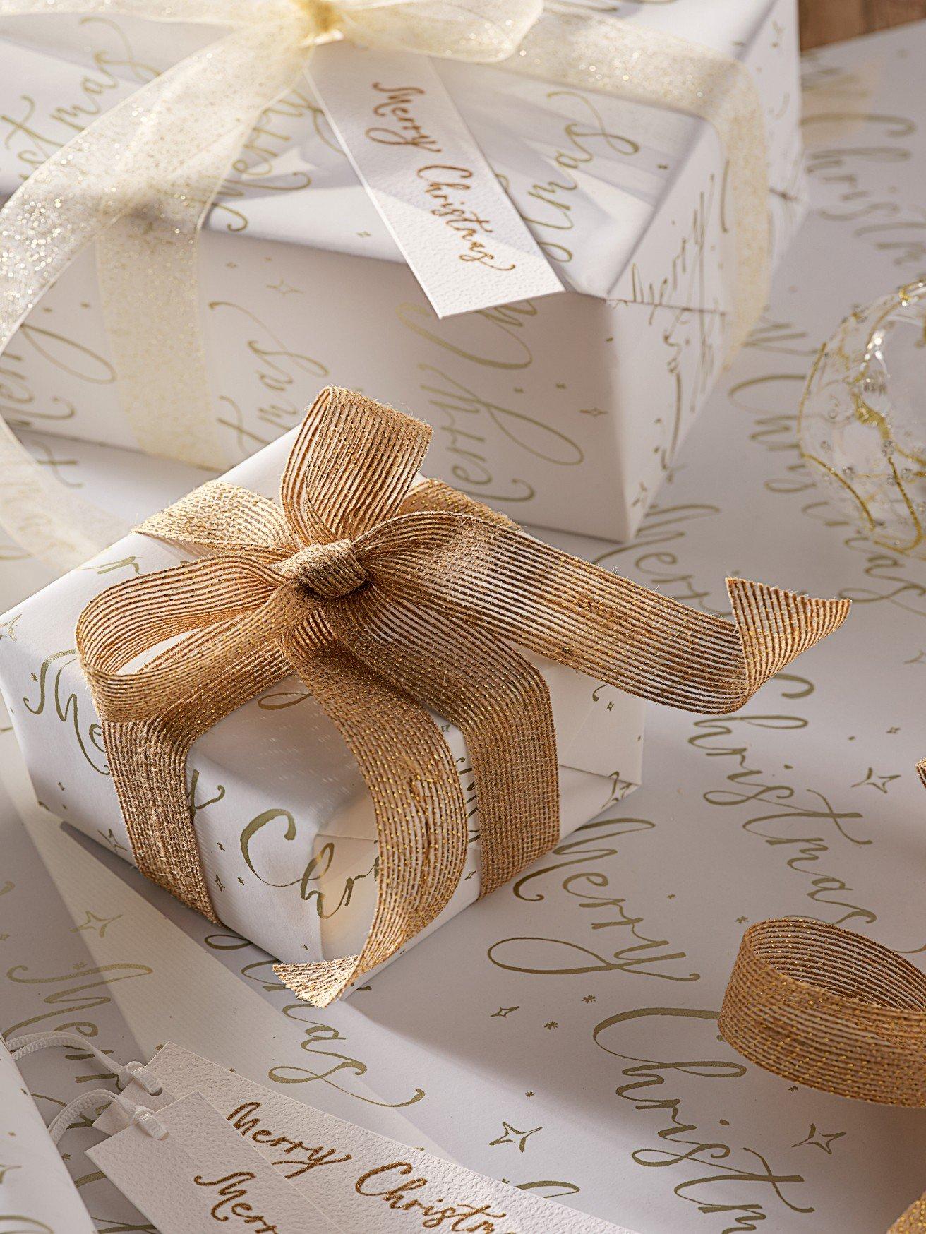 a close up of a white wrapped gift with a bow on it