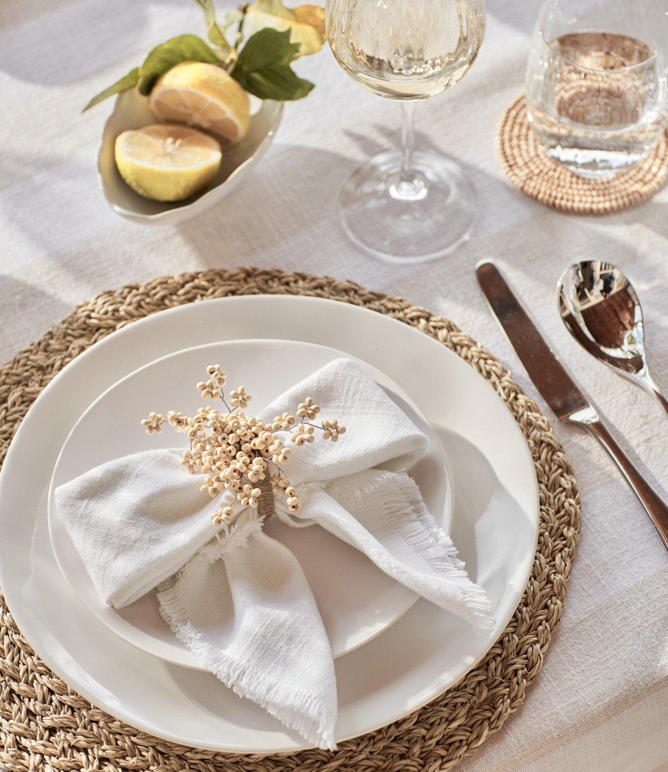 a white plate with a napkin on it next to a fork and knife