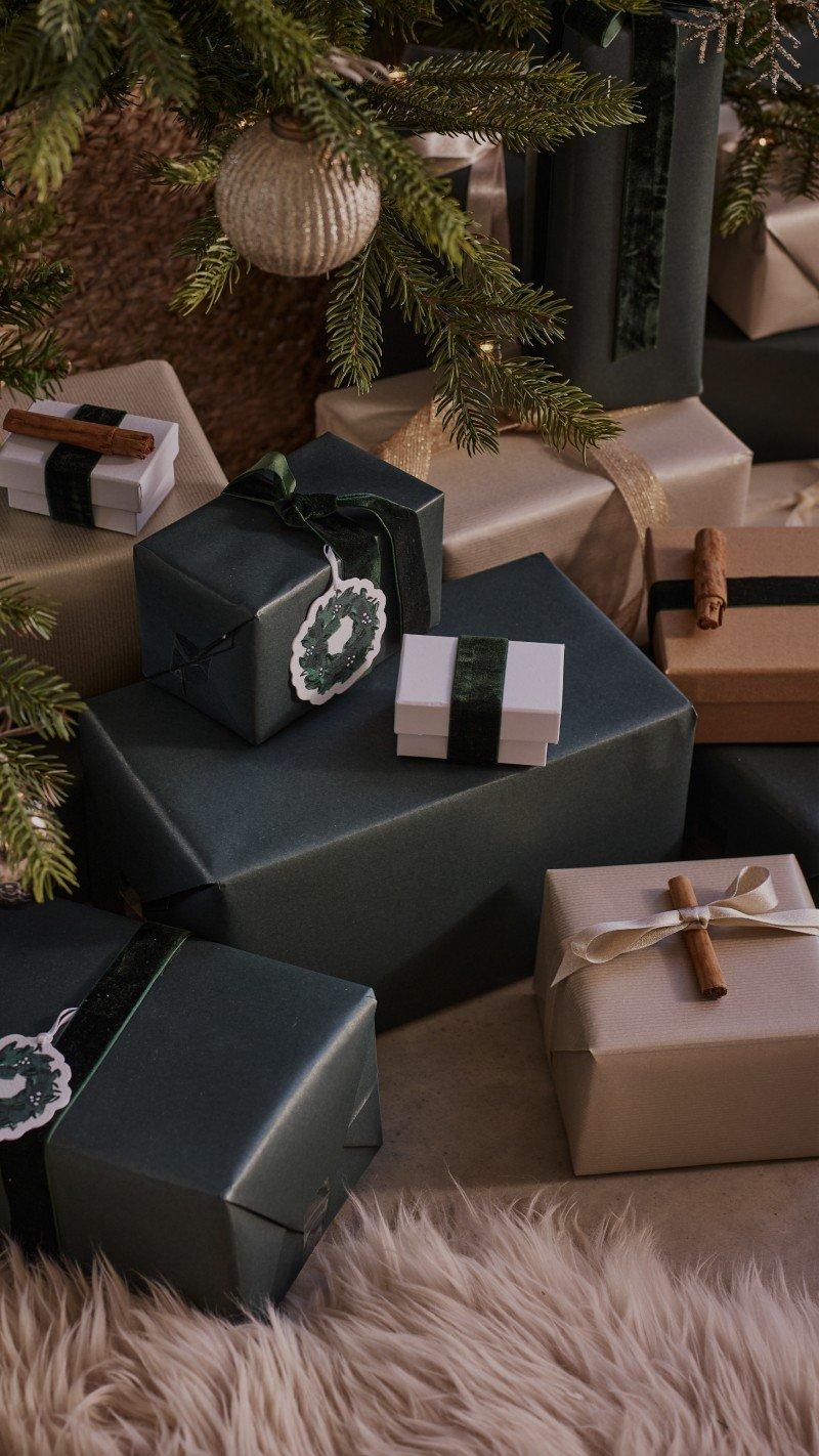 a pile of presents wrapped in brown and green paper