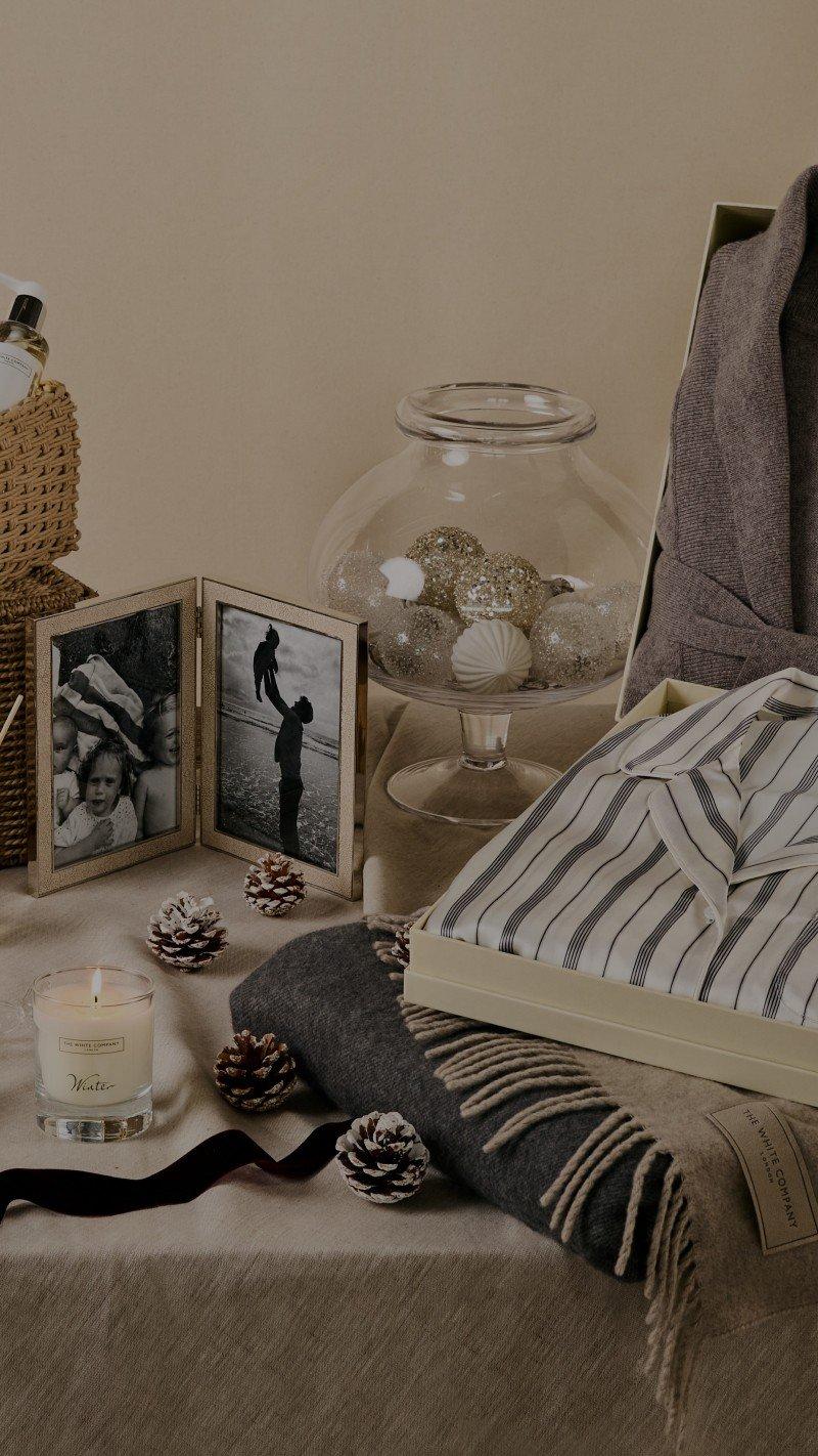 a bed with a candle, a candle holder, and a picture