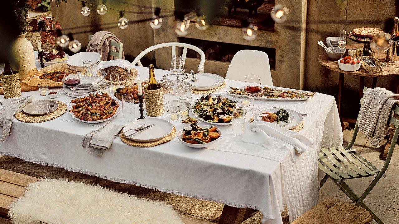 a table set with plates and bowls of food on it