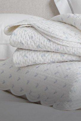 a close up of a white quilt and a white fur blanket