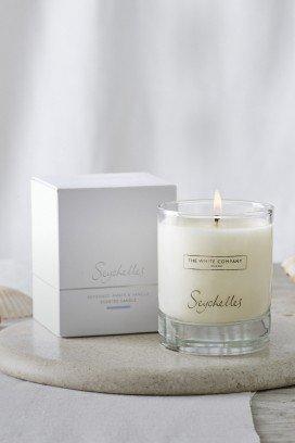 a candle sitting on a marble table next to a box