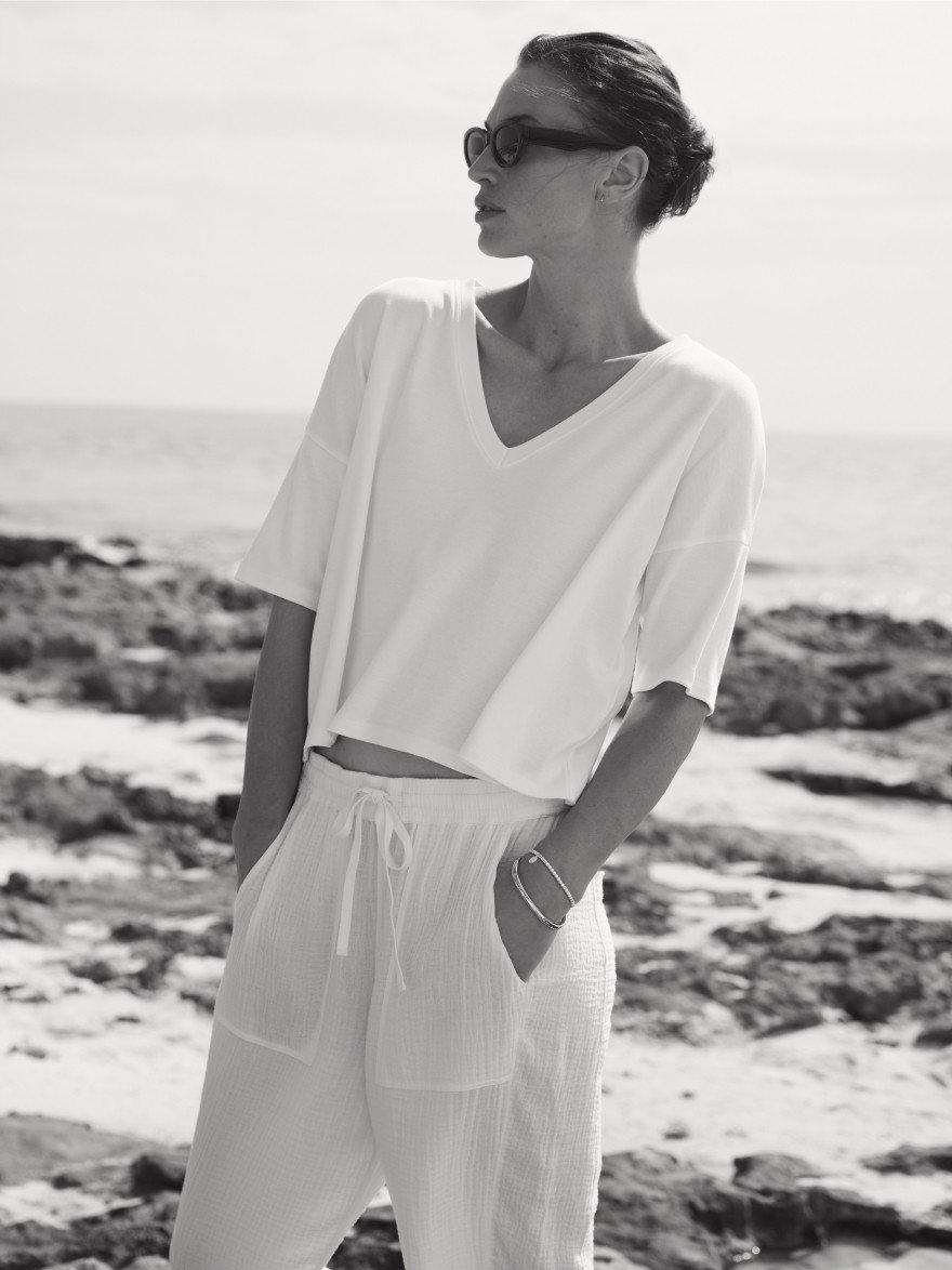 black and white picture of a woman standing outside