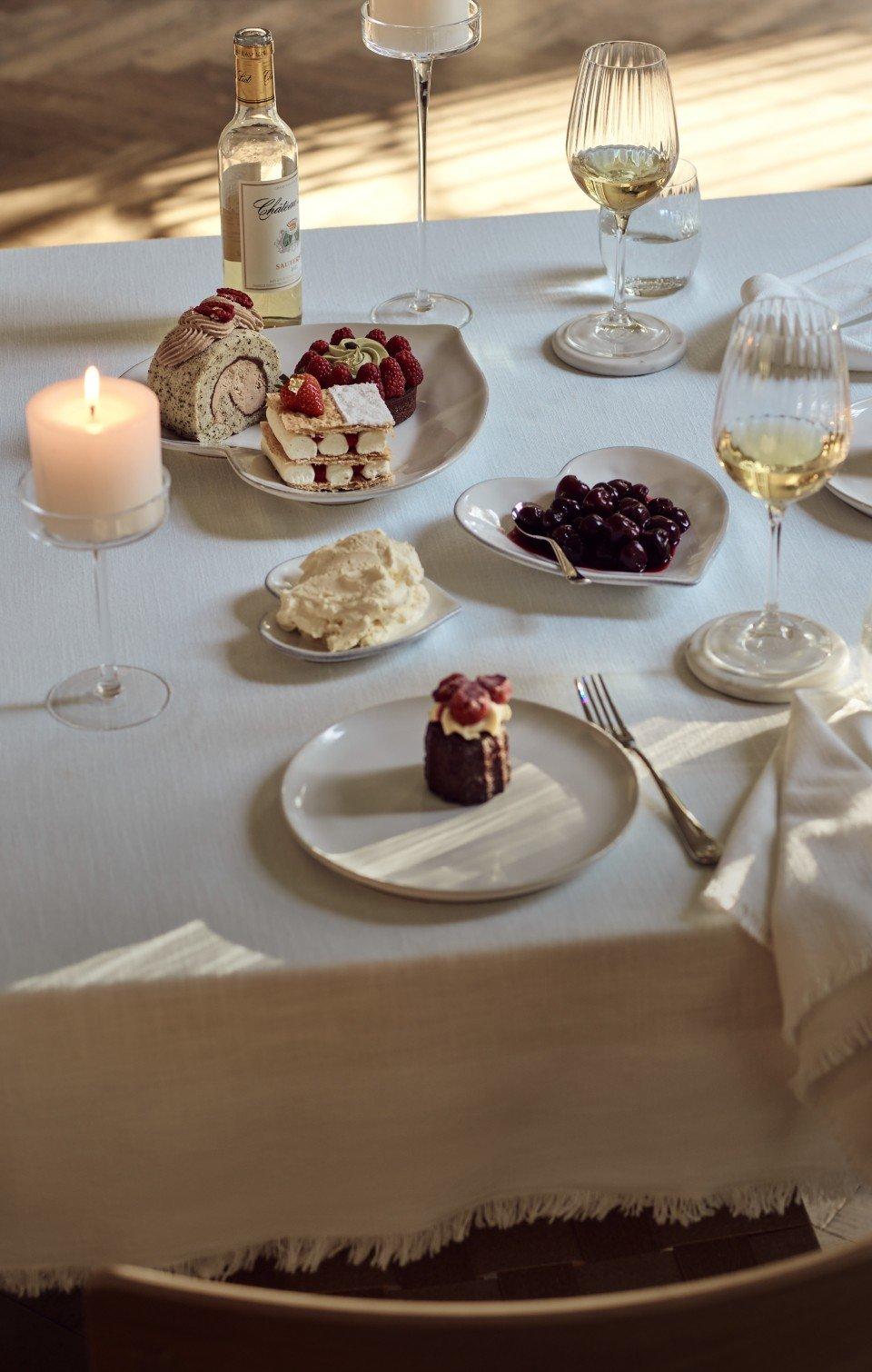 a table with a plate of food and a candle on it