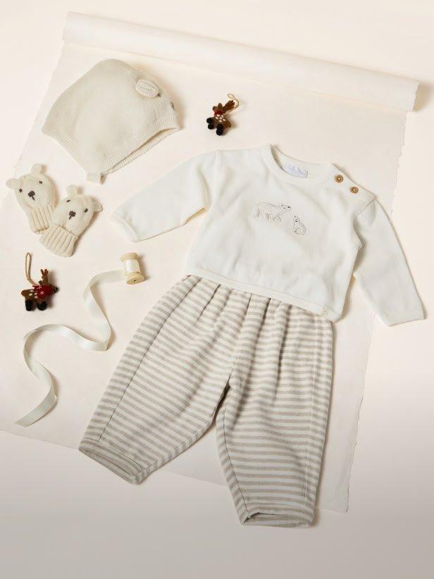 a baby's outfit laid out on a table with accessories