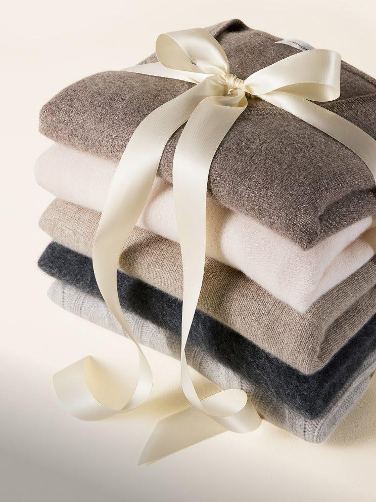 a stack of folded towels with a ribbon tied around them