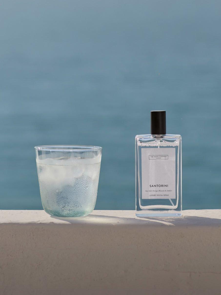 a glass of a glass of water and a bottle of perfume