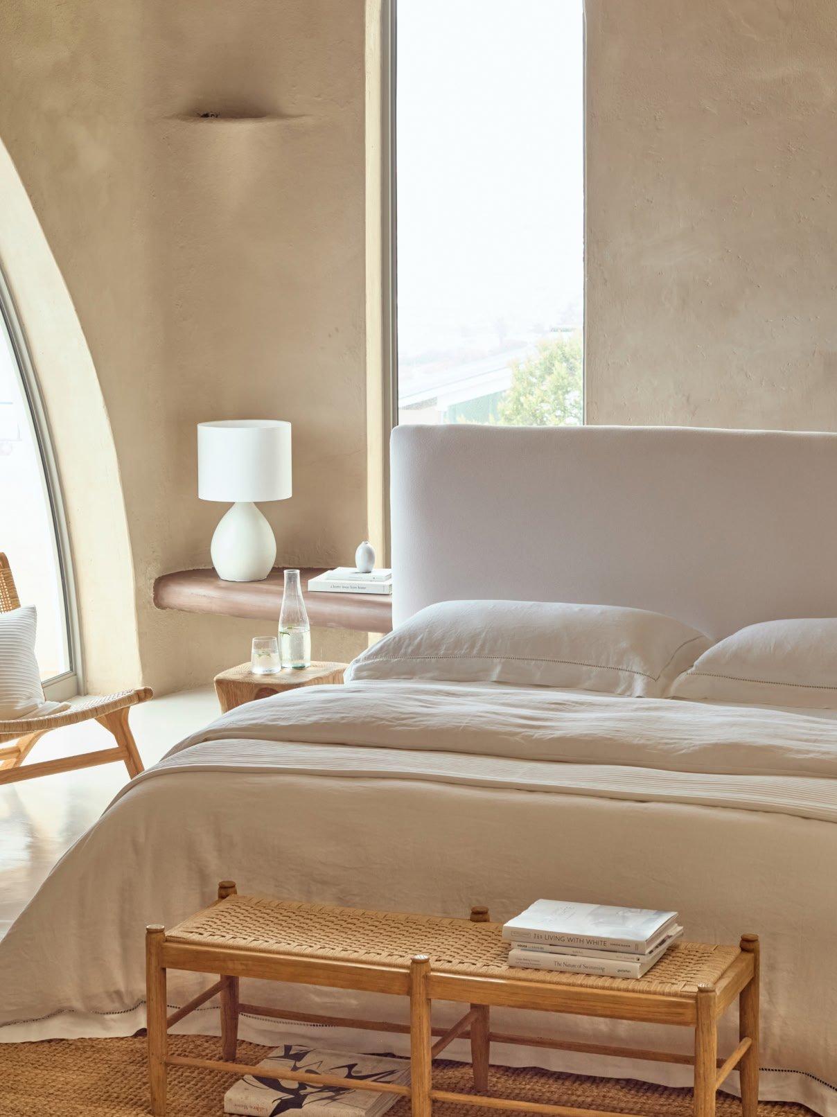 a bedroom with a large bed and a chair in it