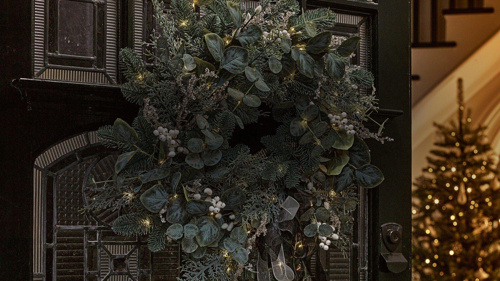 a wreath is hanging on the door of a house