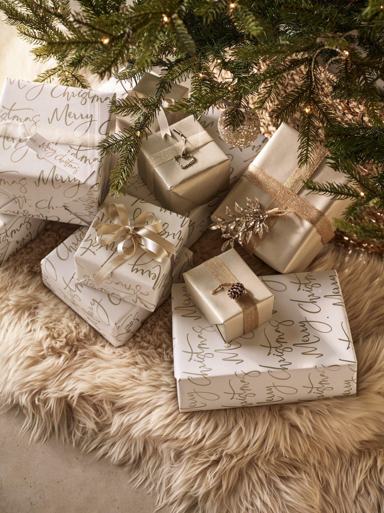 a pile of wrapped presents under a christmas tree