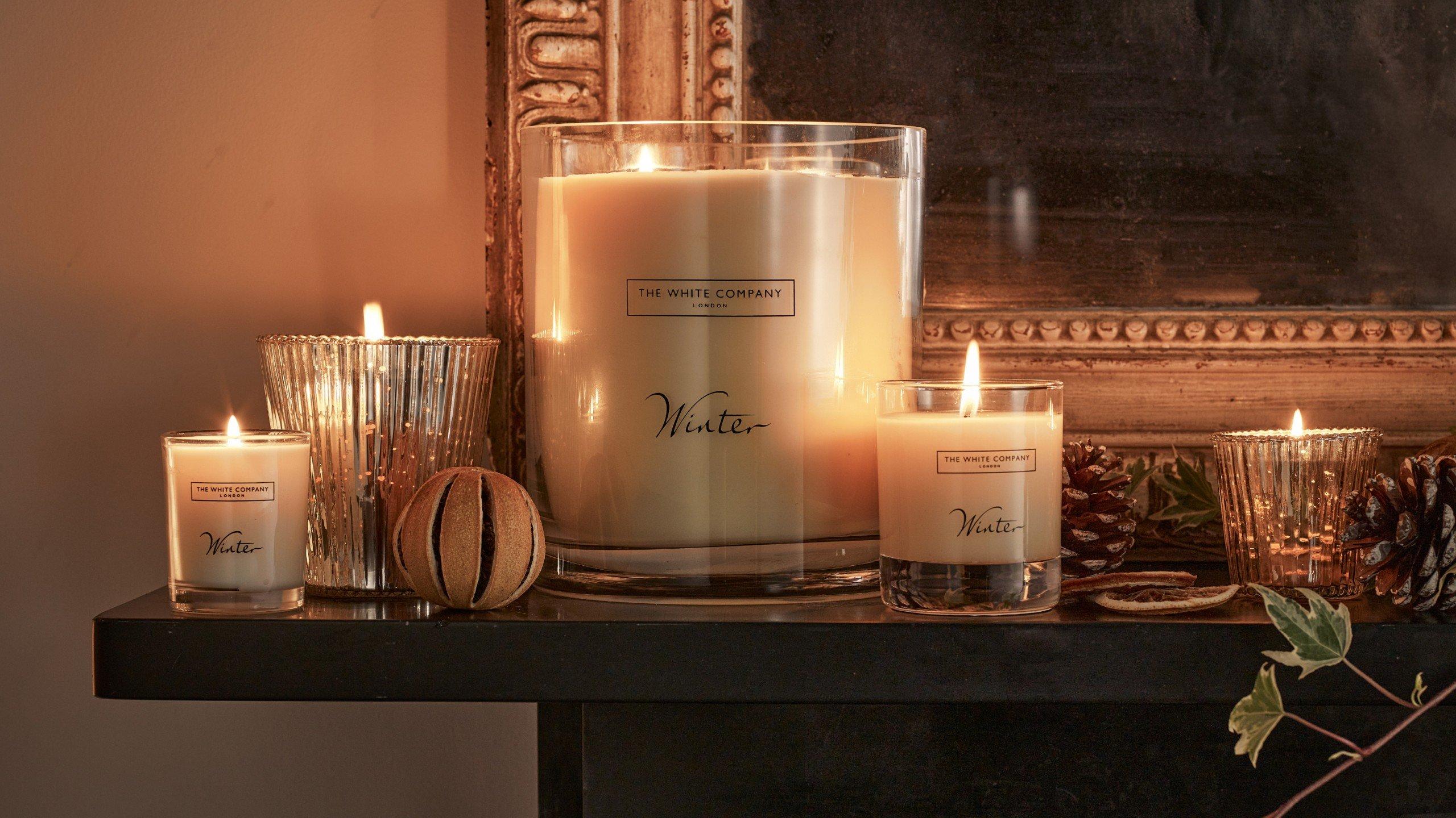 a mantle with candles and other decorations on it