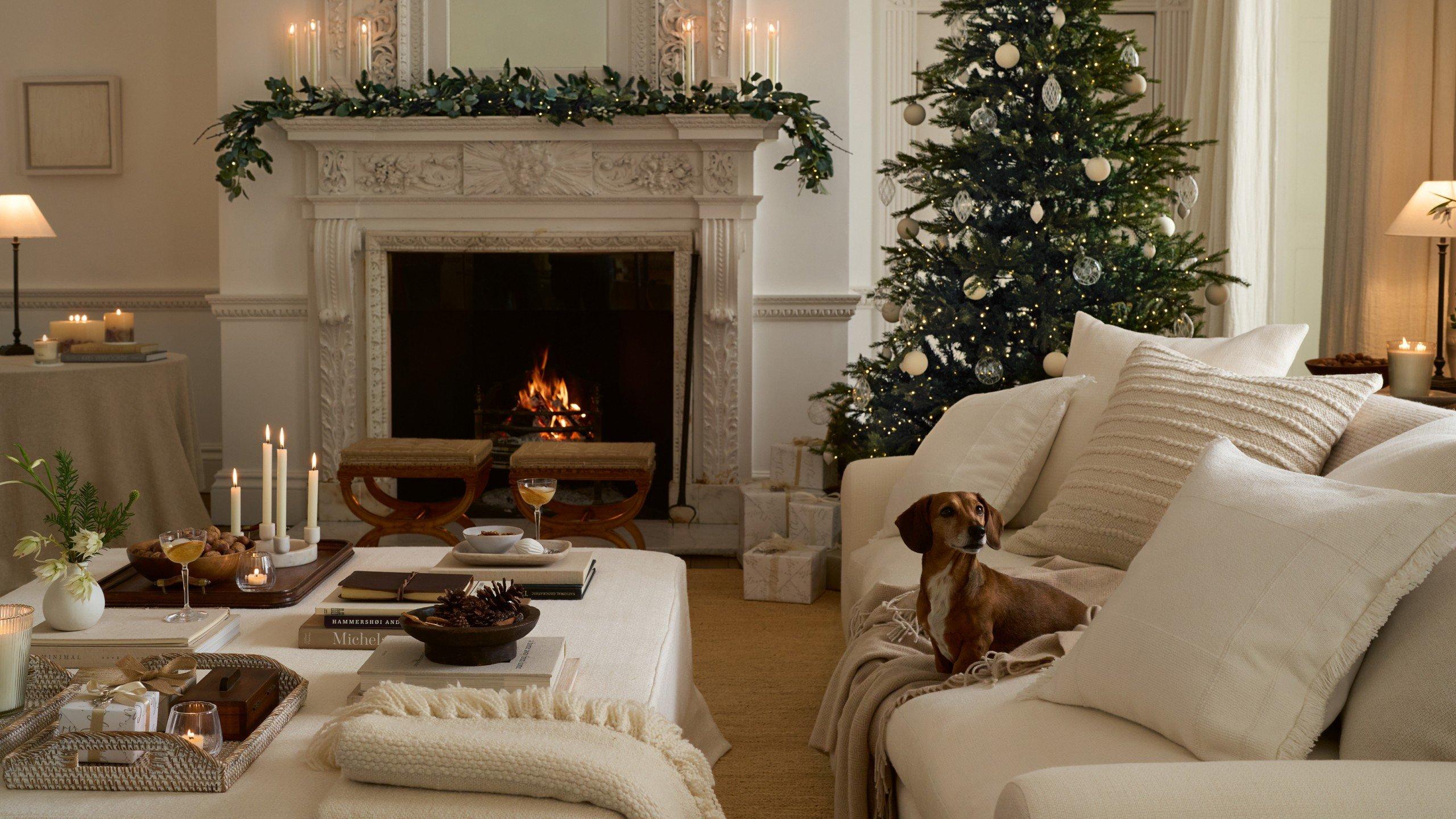 a living room with a fireplace and a christmas tree