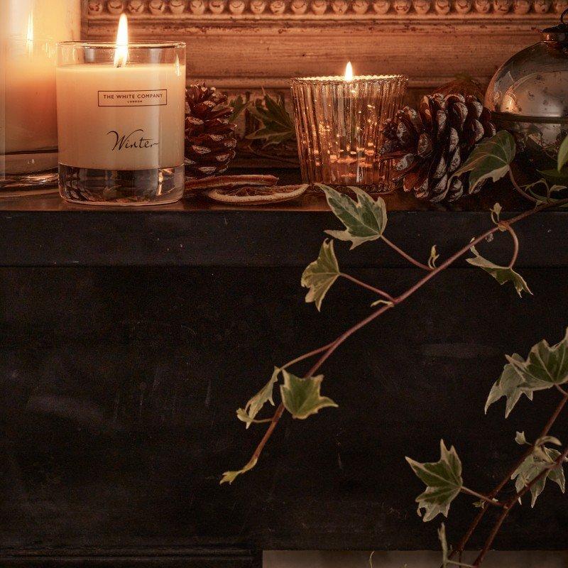 a close up of a plate of food and candles on a table