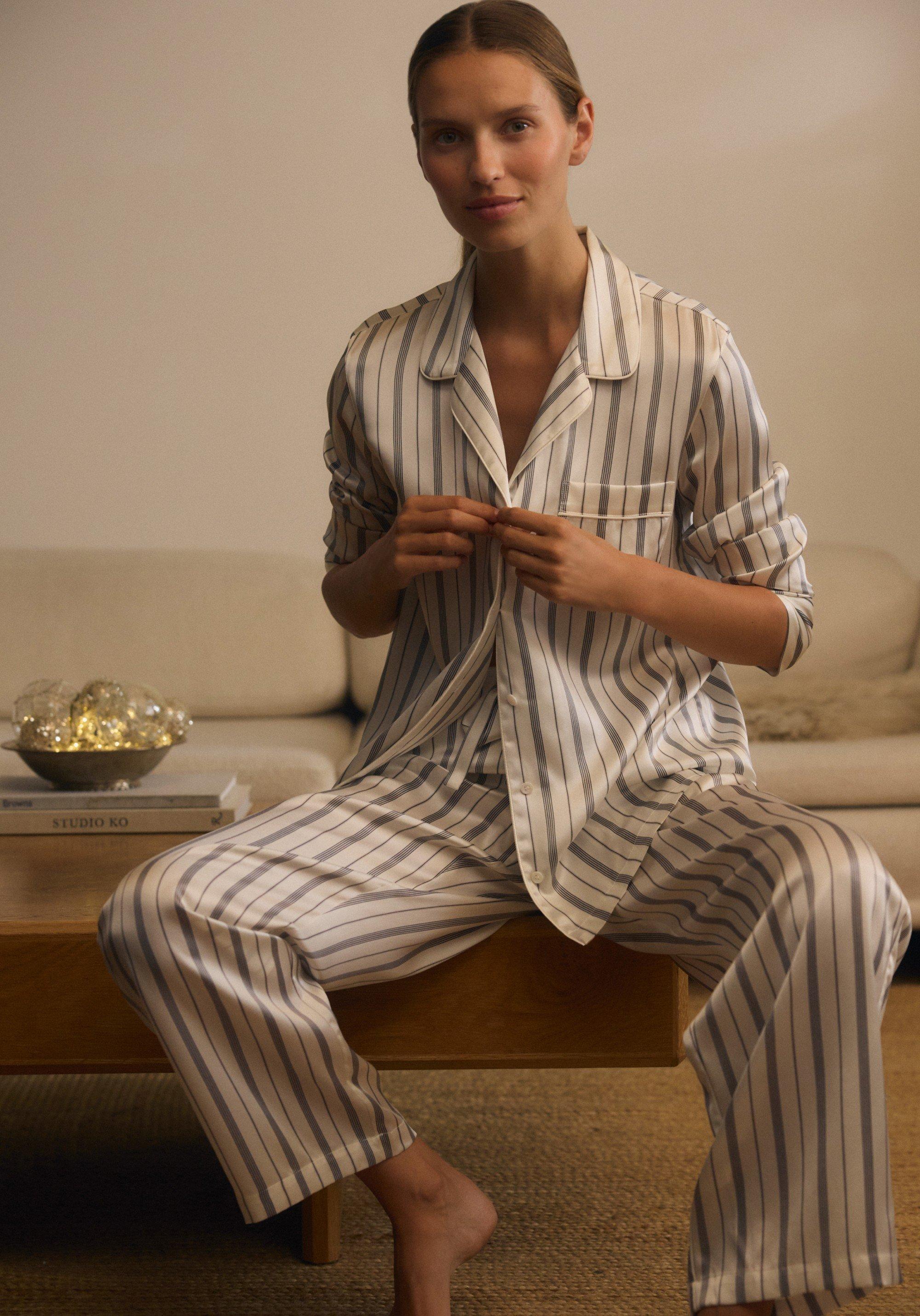 a woman in a pair of silk pyjamas