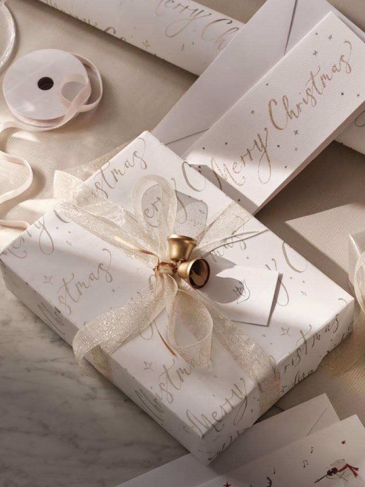 a close up of a wrapped gift with a ribbon and a bell