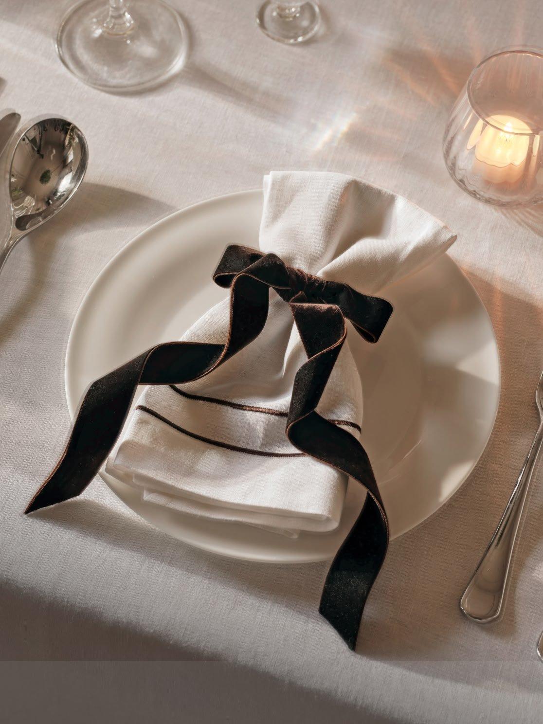 a white plate with a napkin and silverware on it