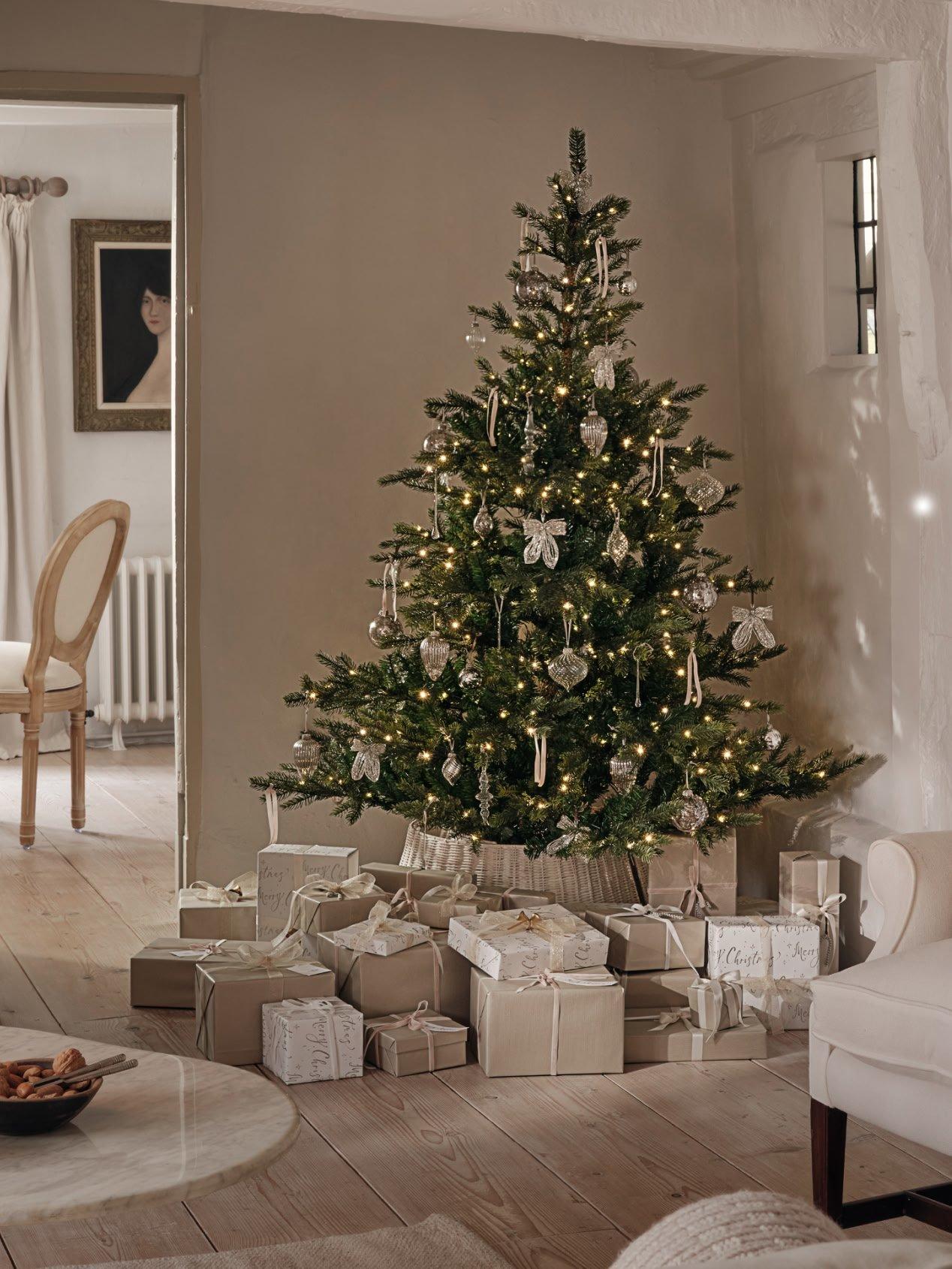 a living room with a christmas tree and presents under it