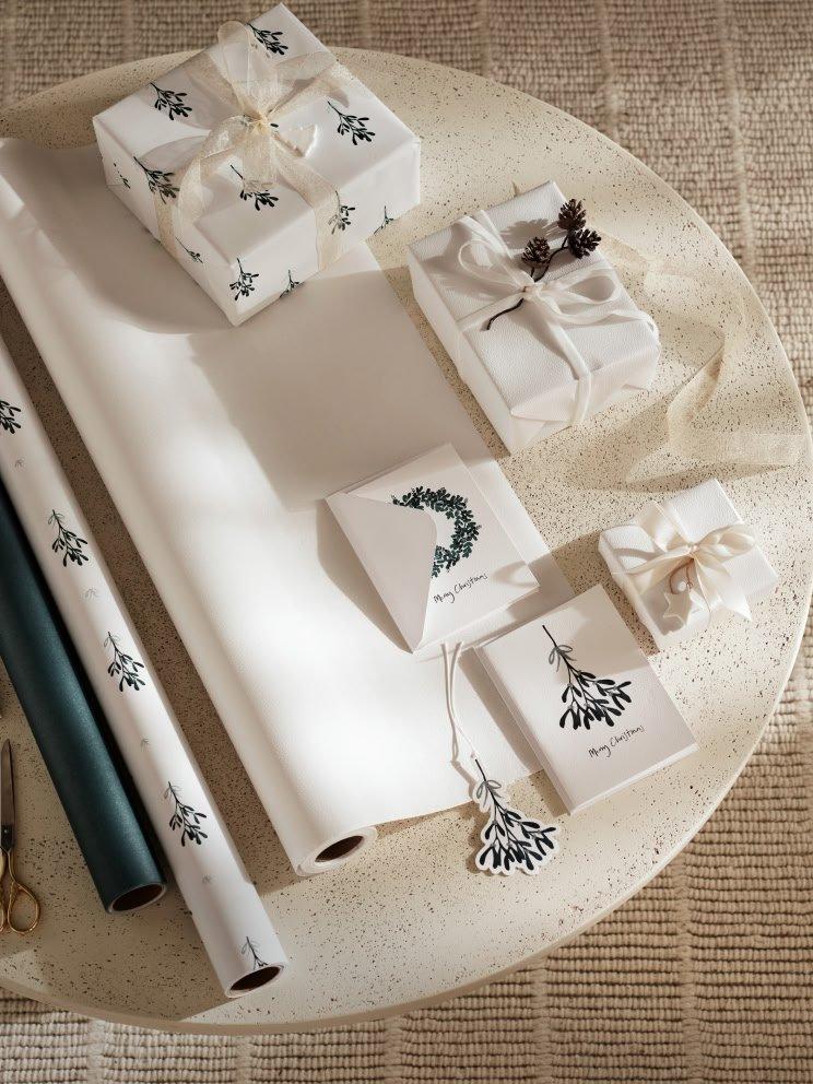 a table with a bunch of wrapping paper and scissors on it