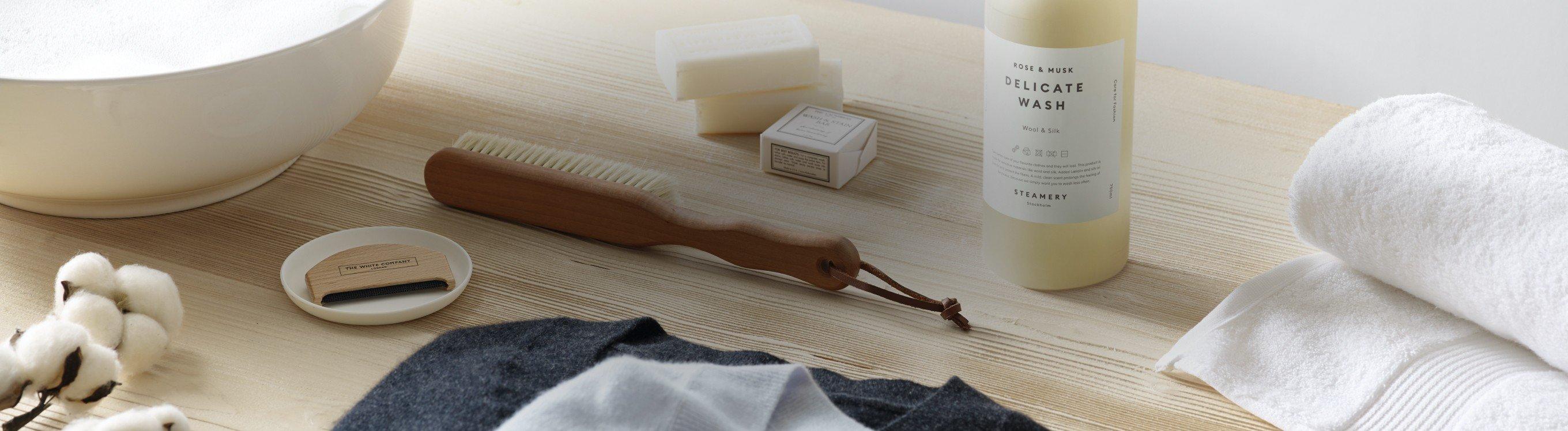 a bathroom counter with a towel, soap, and other items