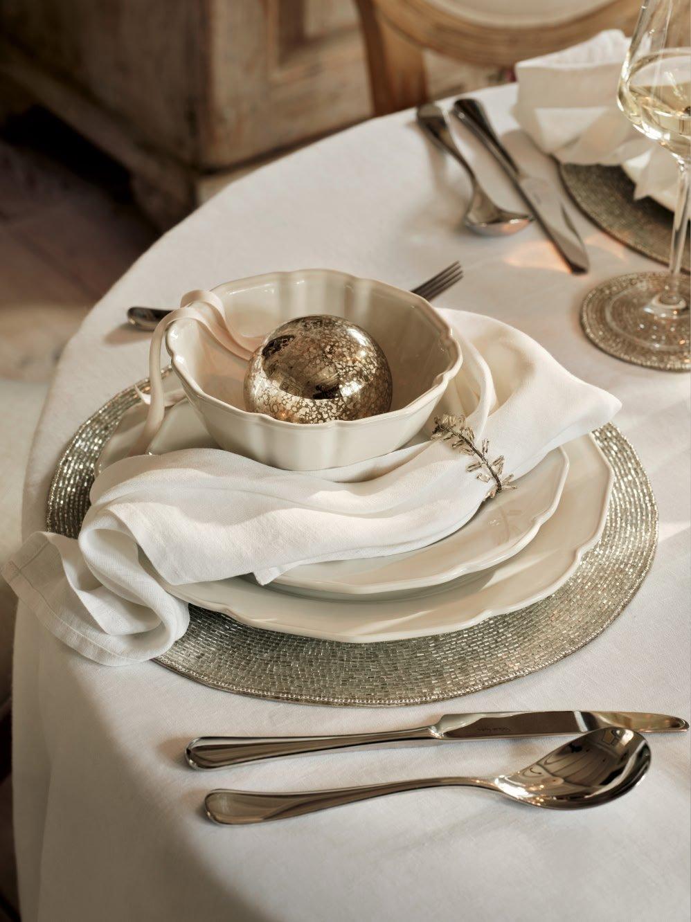 a table setting with silverware and a bowl of fruit