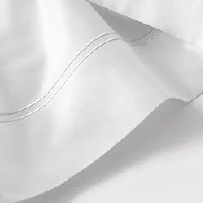 a close up of a white sheet with a wavy edge