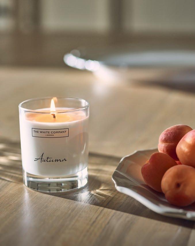 a plate of fruit and a candle on a table