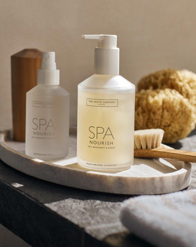 a couple of bottles of spa soap sitting on a tray