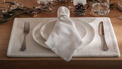 a white napkin on a white plate with silverware on it