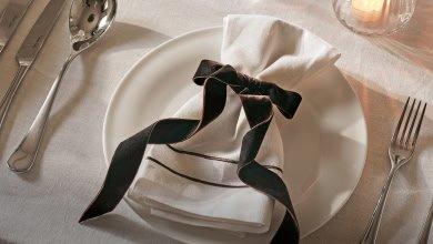 a white plate with a napkin and silverware on it